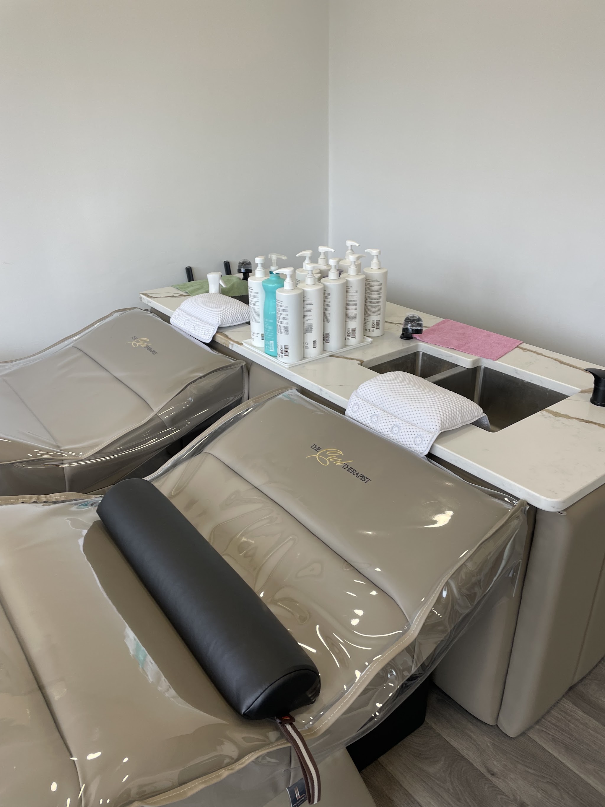 The Curl Therapist's washbasins and hair-care products